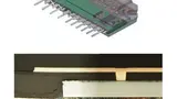 Der Querschliff durch ein eingebettetes Power-SiP, Ersatz für dieses Leistungsmodul, mit einem der eingebetteten IGBT-Chips.