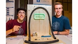 Der Roboter mit dem Namen „CABLEbot“ soll eine Zugschnur in Leerrohre einziehen können, um die Kabelverlegung bei der Elektroinstallation zu vereinfachen. Für diese Entwicklung wurden Karl Lappe (links), Konstantin Hoffmann (rechts) und Wesley Custód