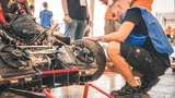 A team member makes preparations for the race car so that all technical tests can be completed.