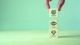 Mission, vision and values of company. Purpose business concept. Hand holds wooden cube with mission vision and values symbols on grey background. Modern vertical design. Business presentation. Banner 